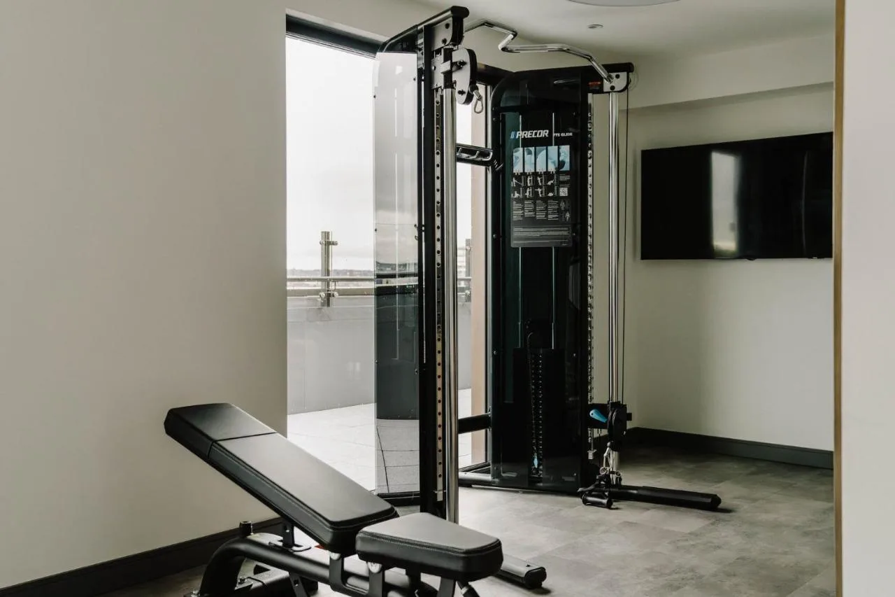 a gym with a treadmill and a mirror at The Halyard Liverpool, Vignette Collection by IHG in Liverpool